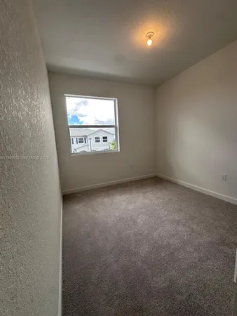 a view of room with walk in closet and bedroom