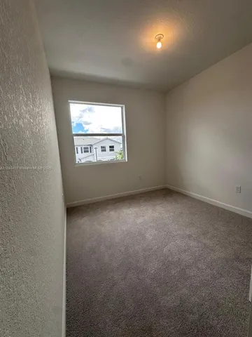 a view of room with walk in closet and bedroom