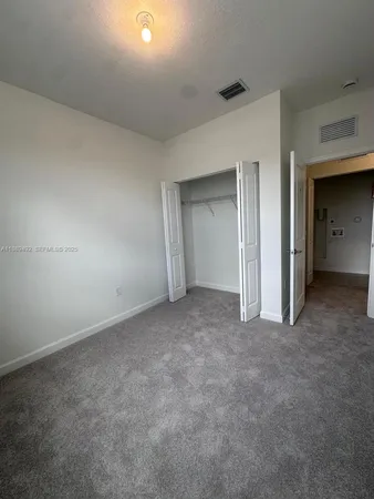 an empty room with windows and entrance