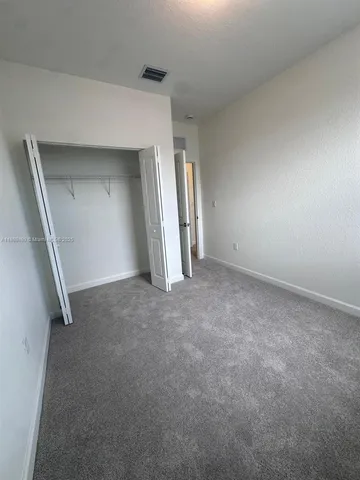 an empty room with windows and entrance