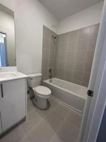 a bathroom with a shower and toilet