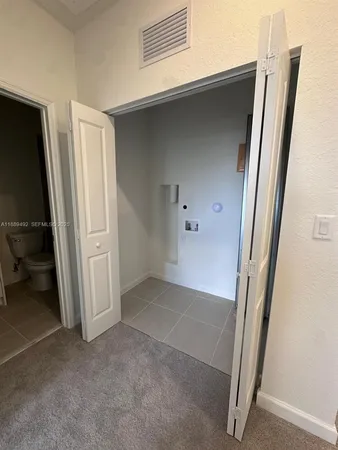 a view of a bathroom with a sink a toilet and a mirror