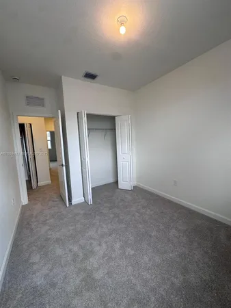 an empty room with a empty space and windows