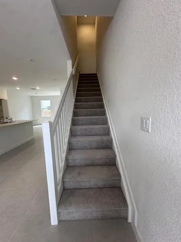a large kitchen with a large counter top and stainless steel appliances