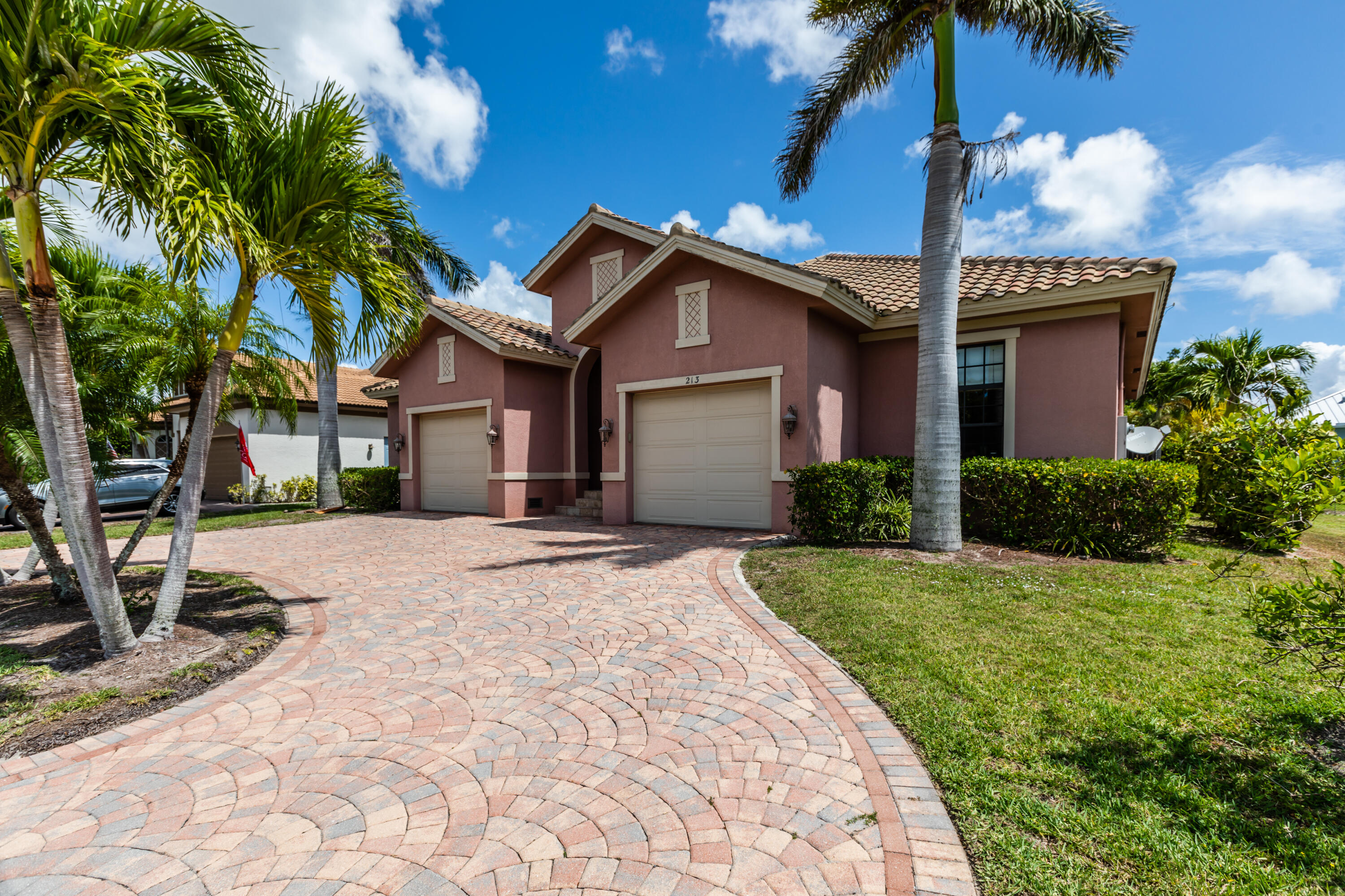 a front view of a house with a garden