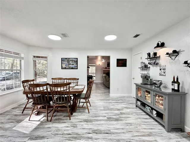 a view of a dining room with furniture and chandelier