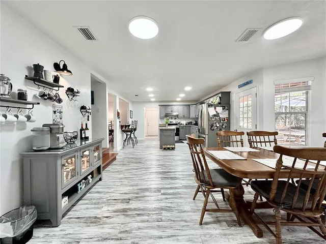 a dining room with furniture and wooden floor