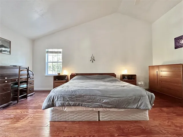a bedroom with a bed and window