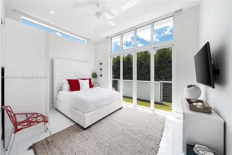 a bedroom with a bed and glass window