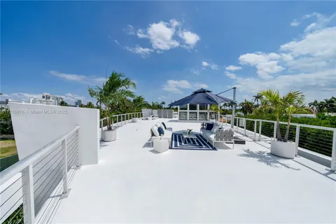 a view of a roof deck with furniture