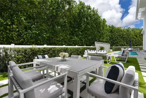 a view of an outside dining space with furniture