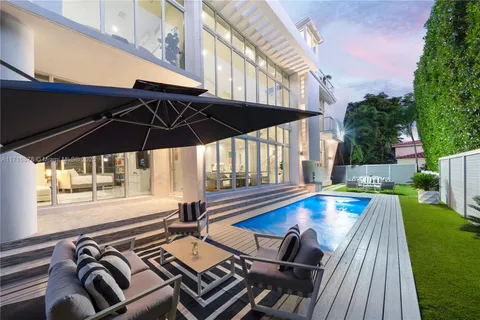 a view of a patio with swimming pool table and chairs