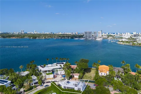 an aerial view of a house with a lake view
