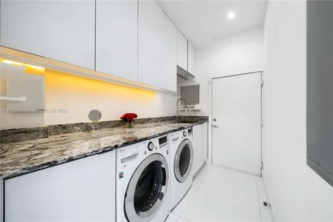 a kitchen with stainless steel appliances granite countertop a sink a stove and a refrigerator