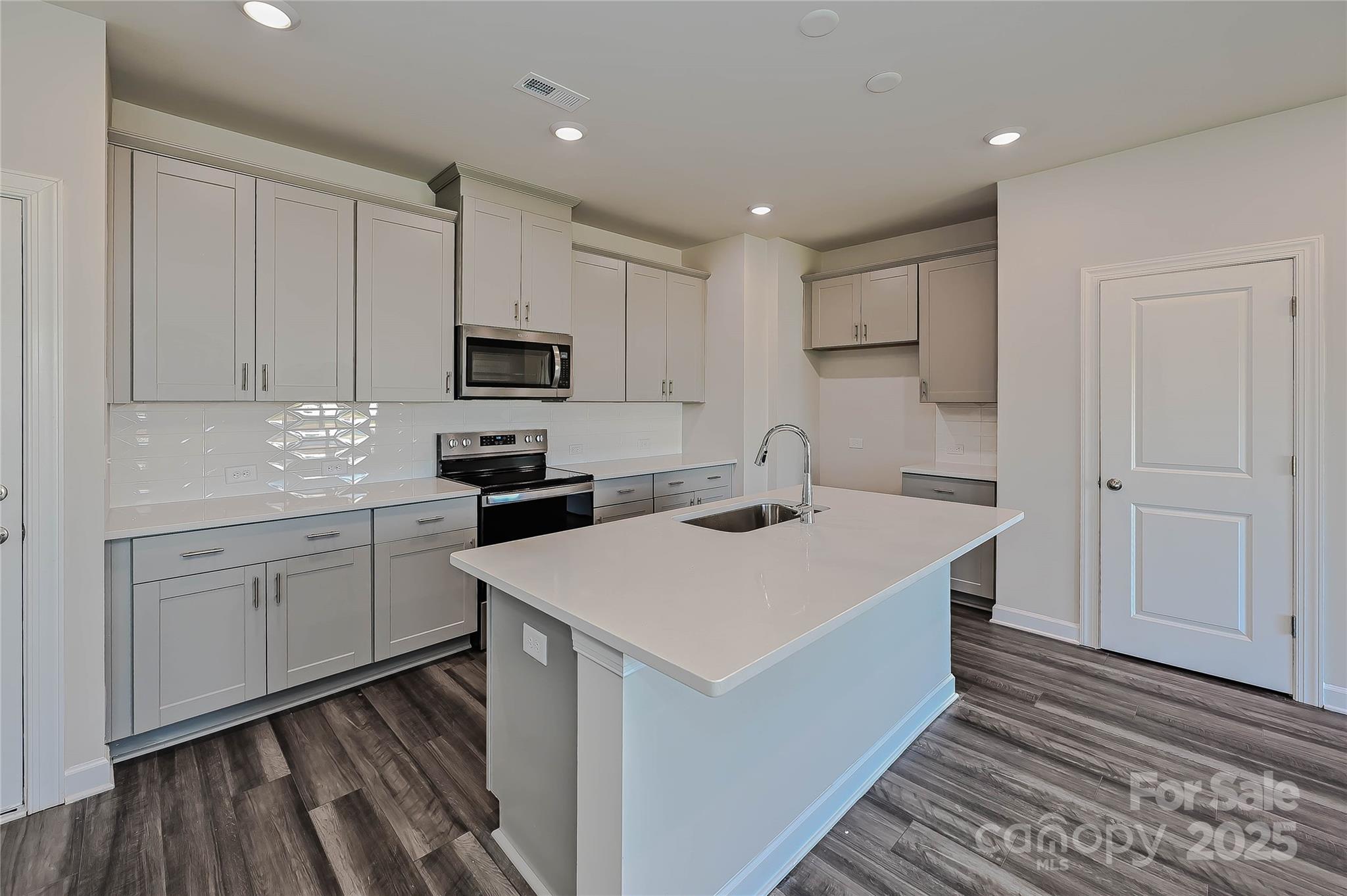5018 Poplin Valley Cherryville, NC 28021 - Photo 5 of 16 a kitchen with a sink stove and refrigerator