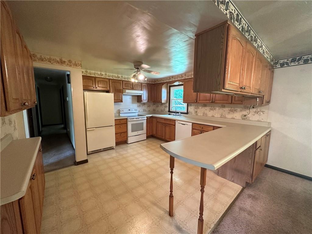 245 T700 Indiana, PA 15701 - Photo 4 of 15 a kitchen with cabinets and white appliances