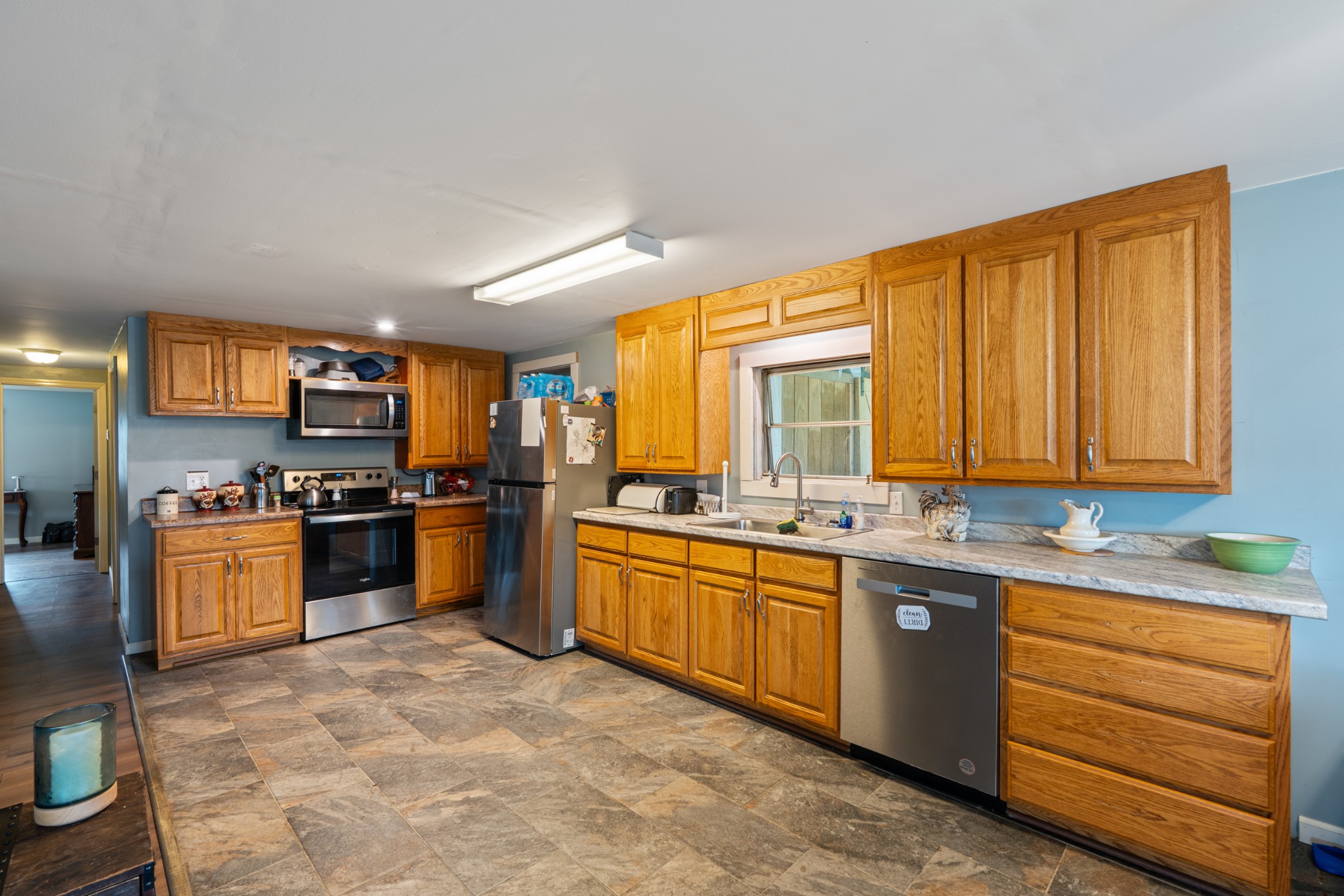 121 Deer Creek Road McEwen, TN 37101 - Photo 23 of 35 a kitchen with stainless steel appliances granite countertop a stove a sink dishwasher and a refrigerator