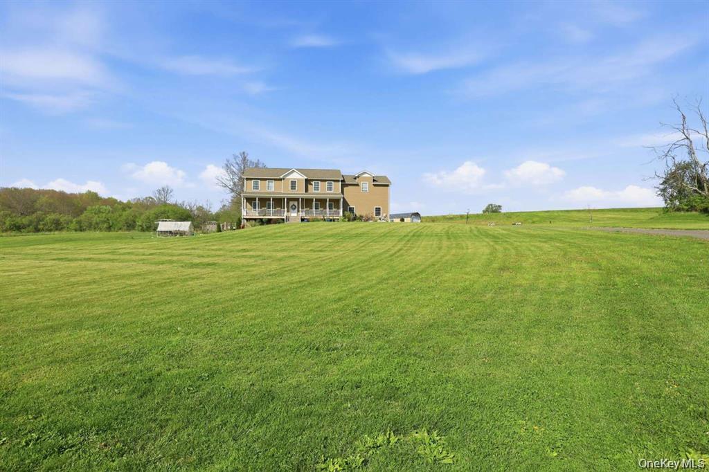 133 Old Chester Road Goshen, NY 10924 - Photo 30 of 33 a view of a big yard with a house in the background