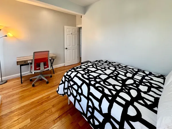 a bedroom with a bed and a chandelier