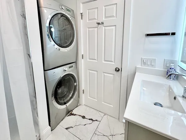 a utility room with sink dryer and washer