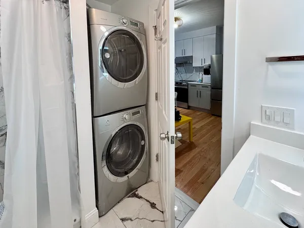 a utility room with sink dryer and washer