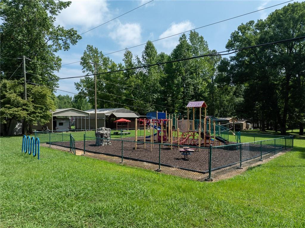 496 Meadow Lane Talking Rock, GA 30175 - Photo 55 of 62 a view of a park with swings and slides