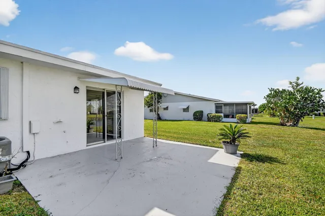 a view of a house with a yard and a garden