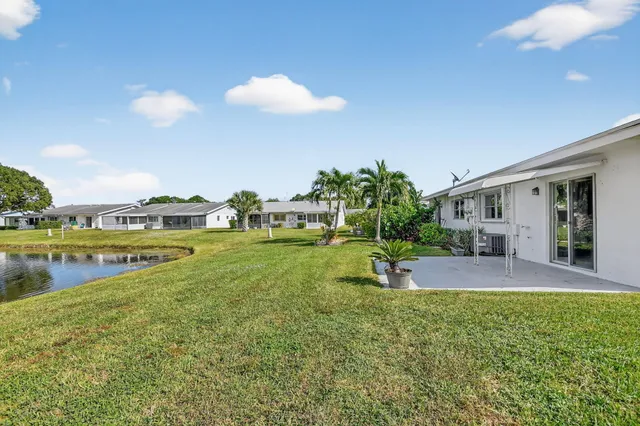 a view of a house with a backyard porch and sitting area