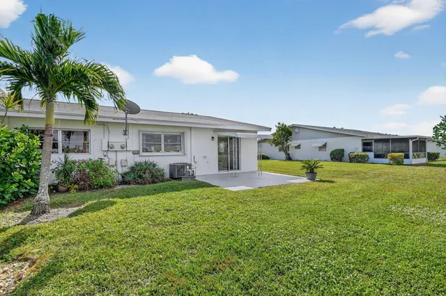 a view of a house with a yard and a pool