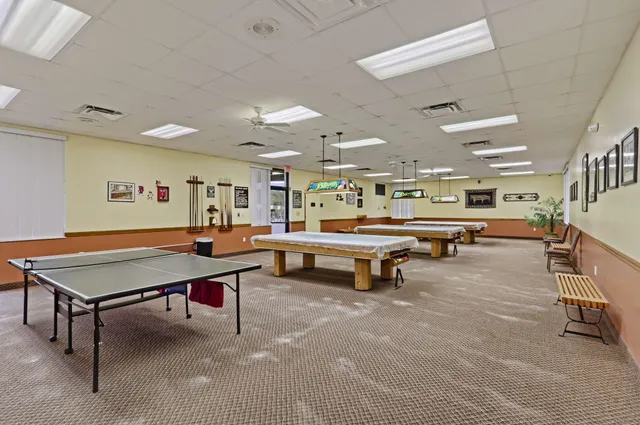 a view of a hallway with wooden cabinets