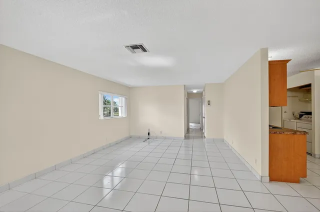 a view of a livingroom with an empty space and a window