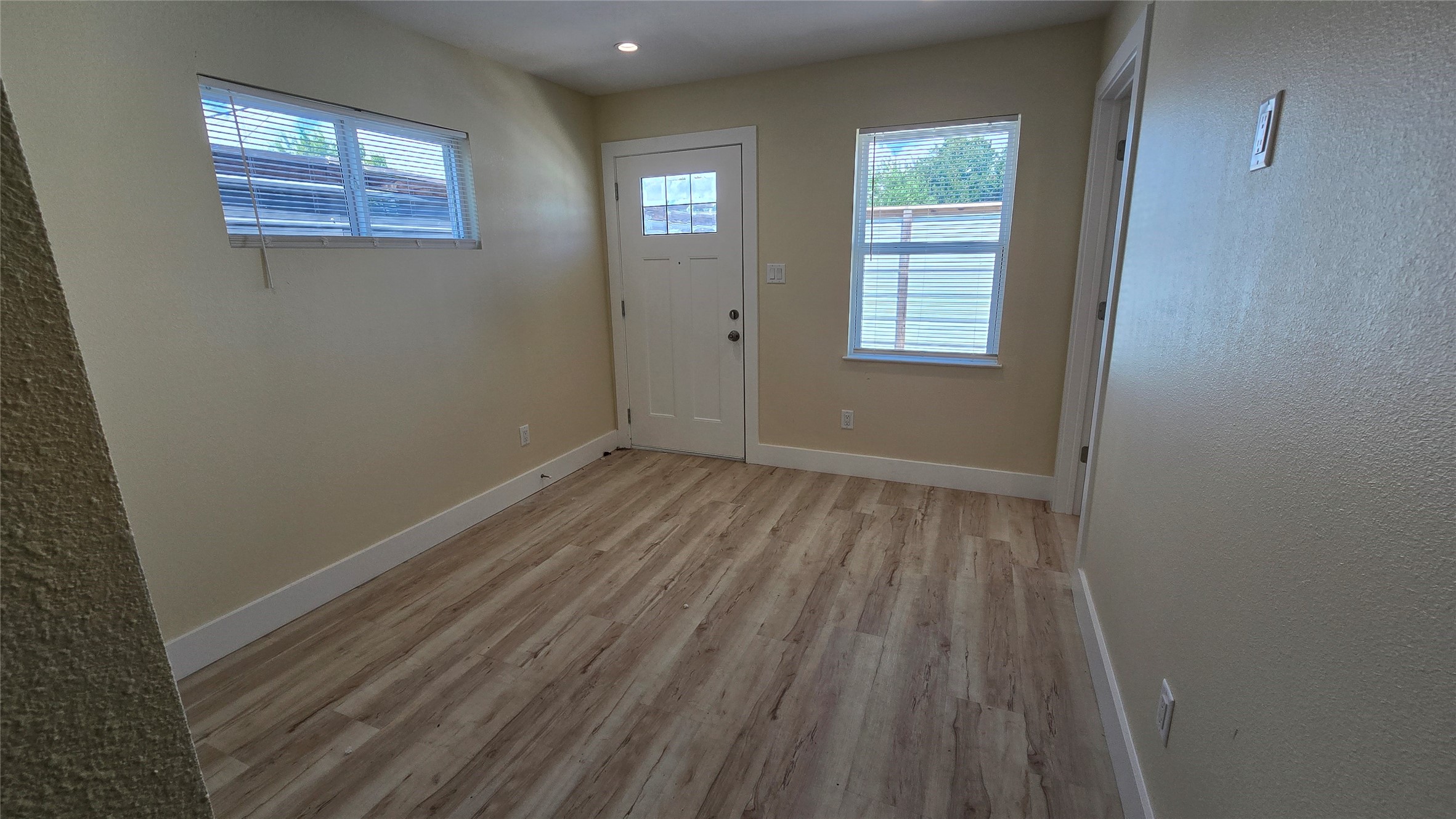 3741 Seabrook Street Houston, TX 77021 - Photo 12 of 50 a view of an empty room with wooden floor and a window