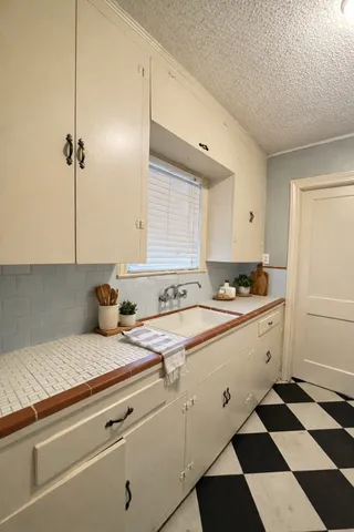 a kitchen with a sink a stove and a refrigerator