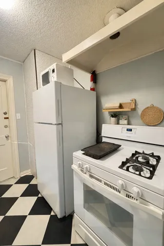 a kitchen with a stove and a refrigerator