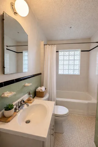 a bathroom with a sink a toilet and bathtub