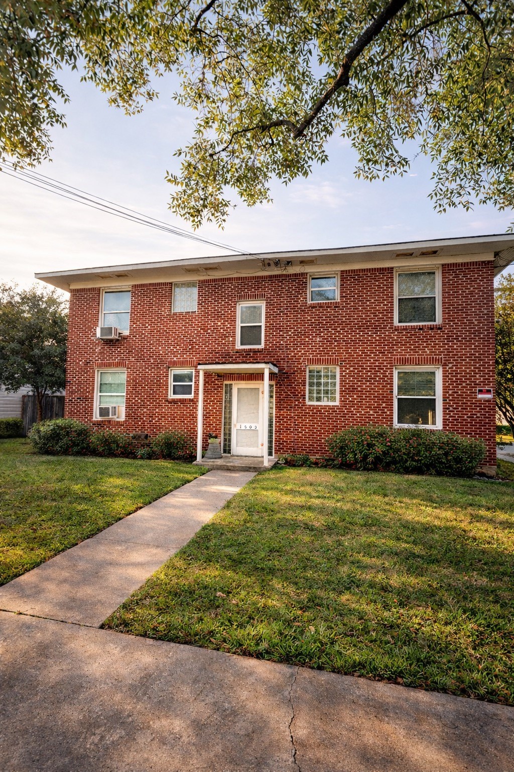 1502 Elmen Street, Unit 3 Houston, TX 77019 - Photo 7 of 7 front view of a brick house with a yard