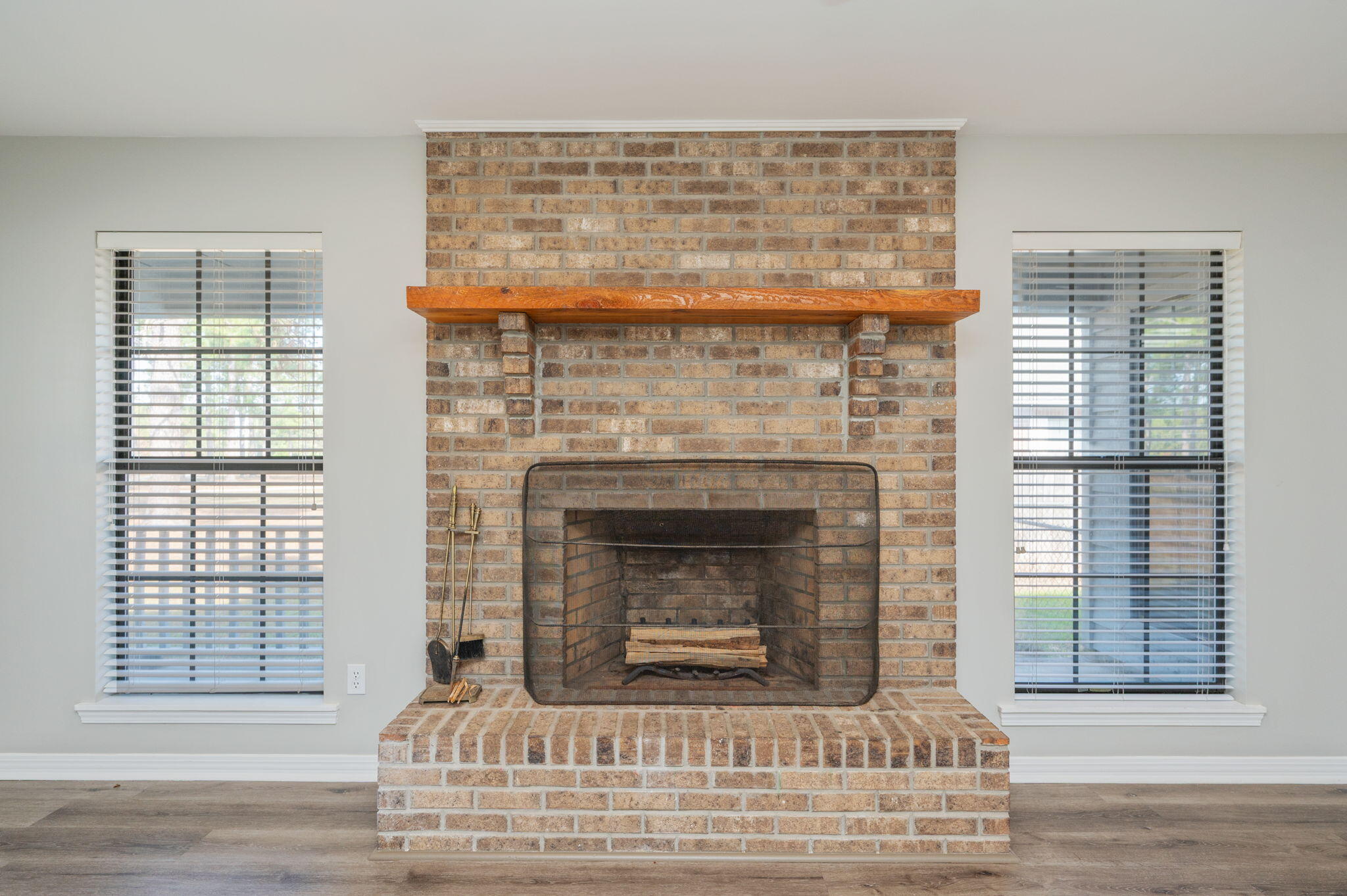 1136 10 Lake Drive DeFuniak Springs, FL 32433 - Photo 13 of 53 a living room with a fireplace and wooden floor