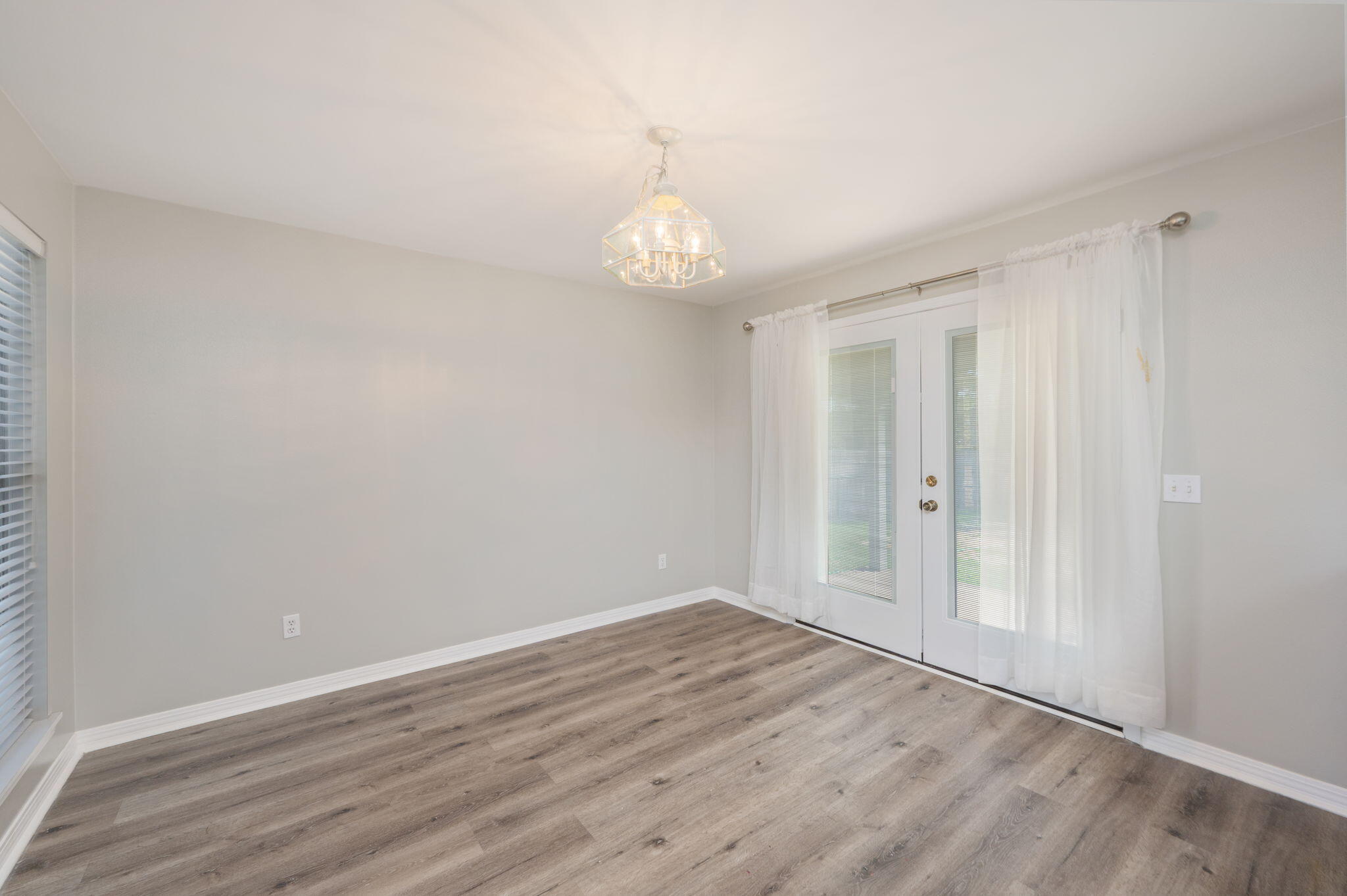 1136 10 Lake Drive DeFuniak Springs, FL 32433 - Photo 14 of 53 a view of an empty room with wooden floor