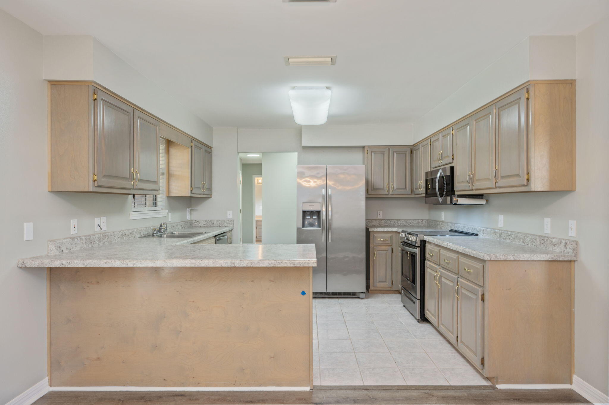 1136 10 Lake Drive DeFuniak Springs, FL 32433 - Photo 15 of 53 a kitchen with stainless steel appliances granite countertop a sink stove and refrigerator