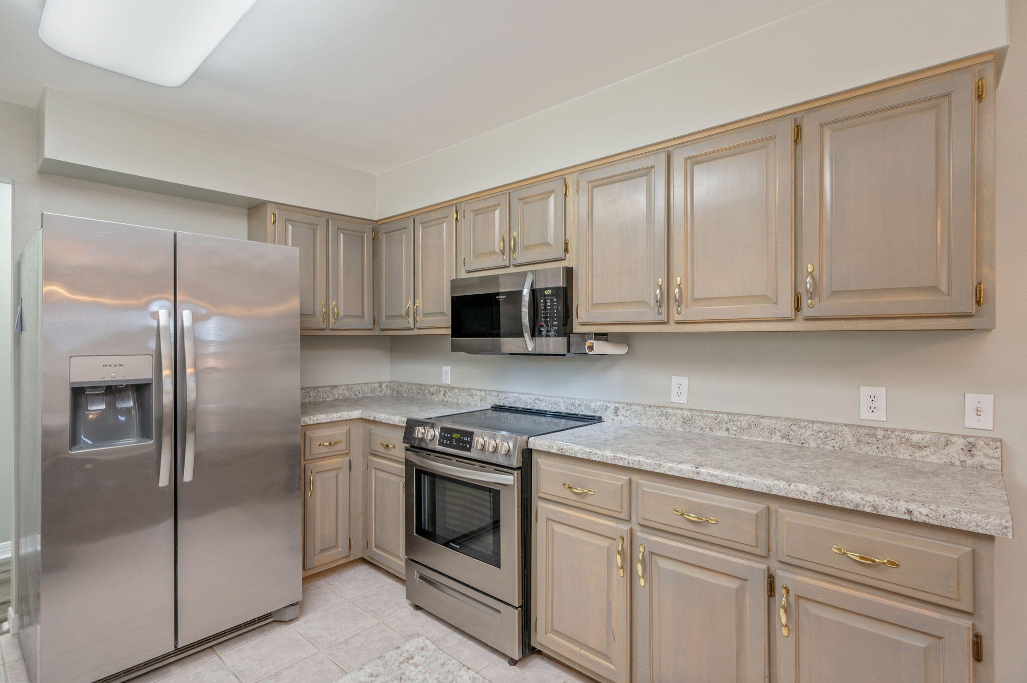 1136 10 Lake Drive DeFuniak Springs, FL 32433 - Photo 16 of 53 a kitchen with stainless steel appliances granite countertop a refrigerator a stove and white cabinets