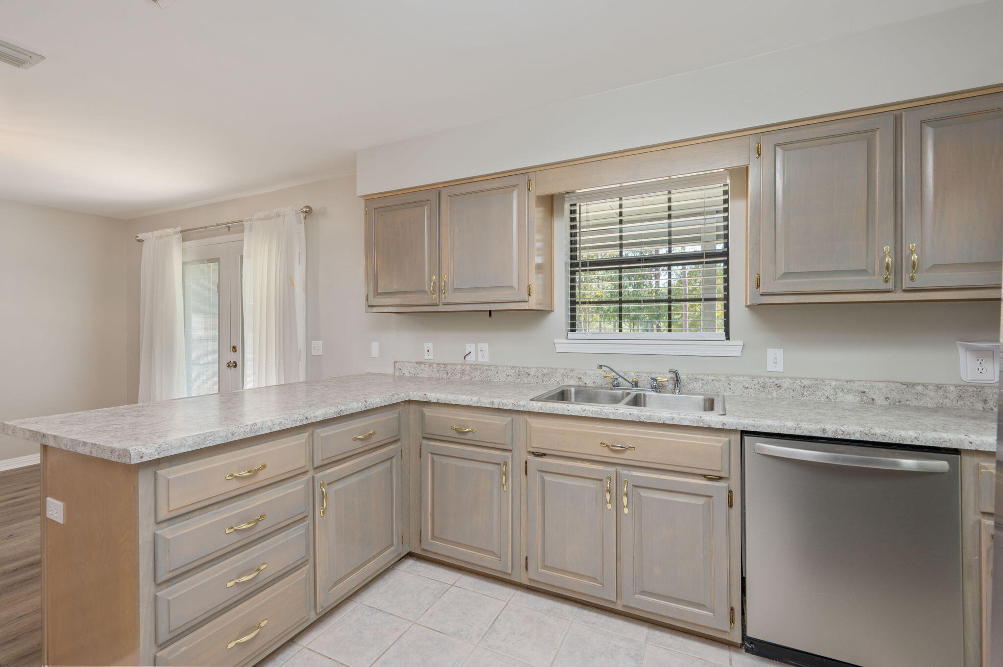 1136 10 Lake Drive DeFuniak Springs, FL 32433 - Photo 17 of 53 a kitchen with white cabinets and sink