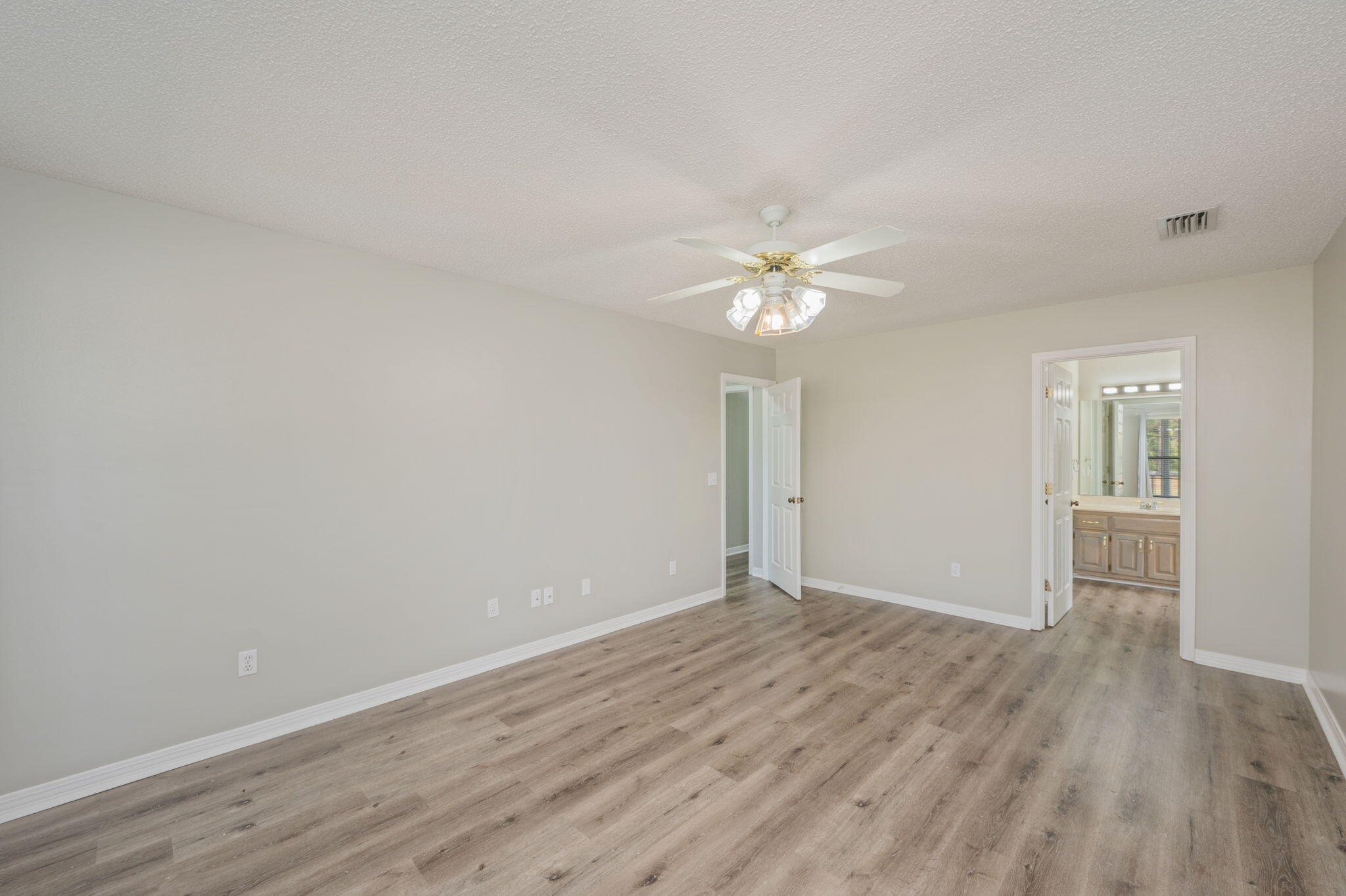 1136 10 Lake Drive DeFuniak Springs, FL 32433 - Photo 22 of 53 a view of an empty room with wooden floor