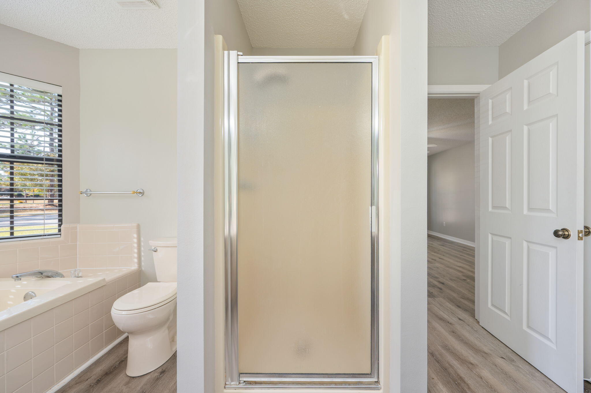 1136 10 Lake Drive DeFuniak Springs, FL 32433 - Photo 24 of 53 a bathroom with a granite countertop toilet a sink and a mirror