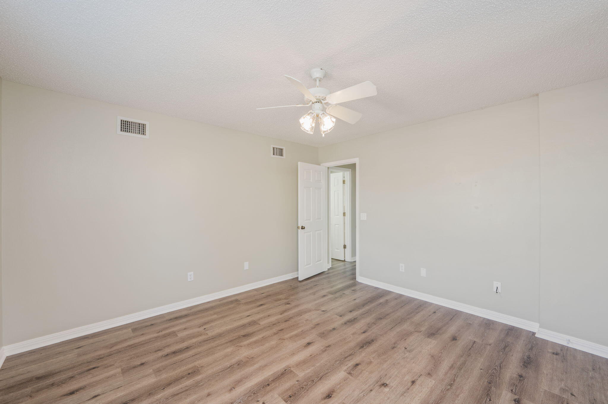 1136 10 Lake Drive DeFuniak Springs, FL 32433 - Photo 33 of 53 a view of an empty room with wooden floor