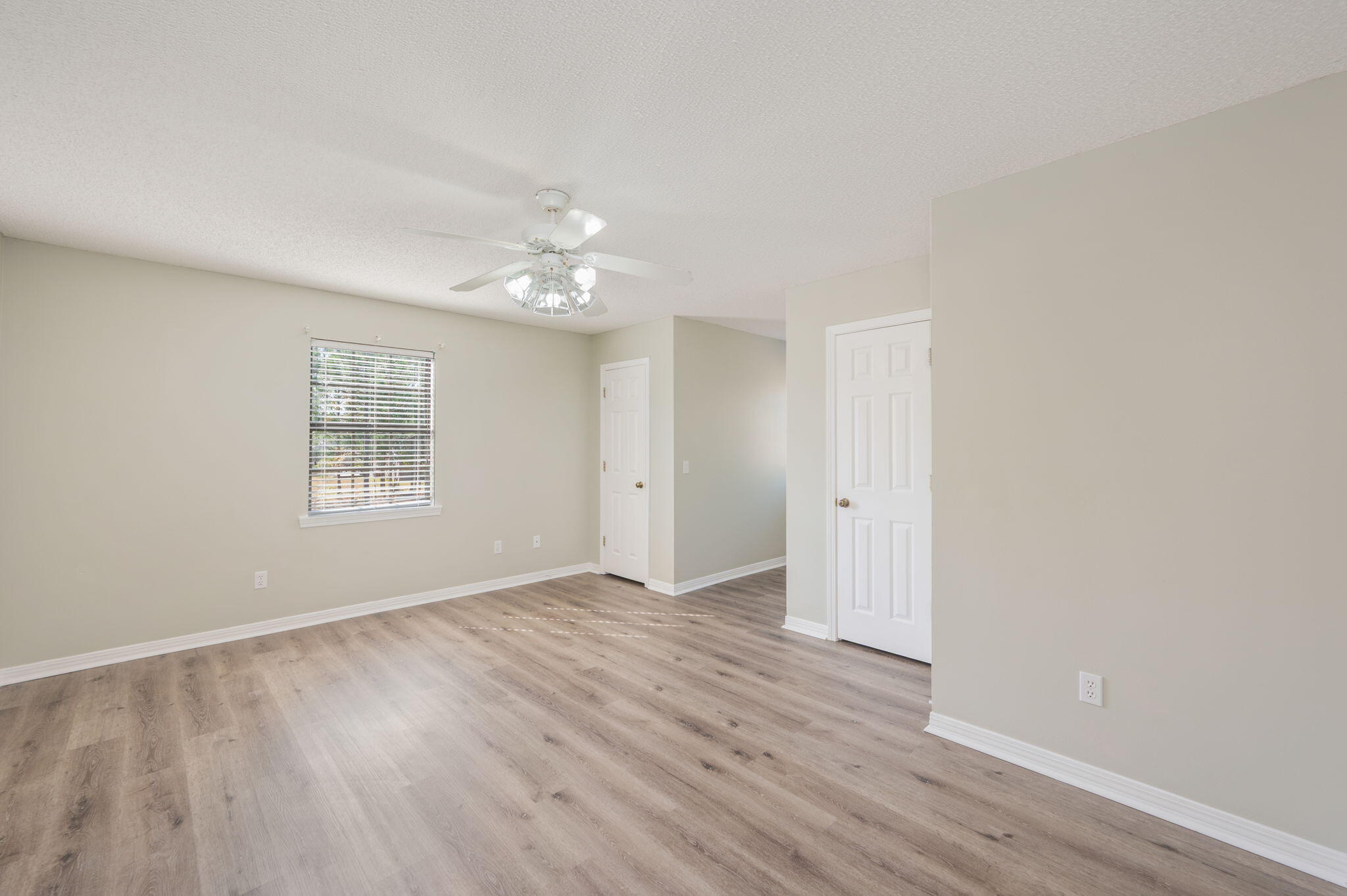 1136 10 Lake Drive DeFuniak Springs, FL 32433 - Photo 34 of 53 a view of an empty room with wooden floor and a window