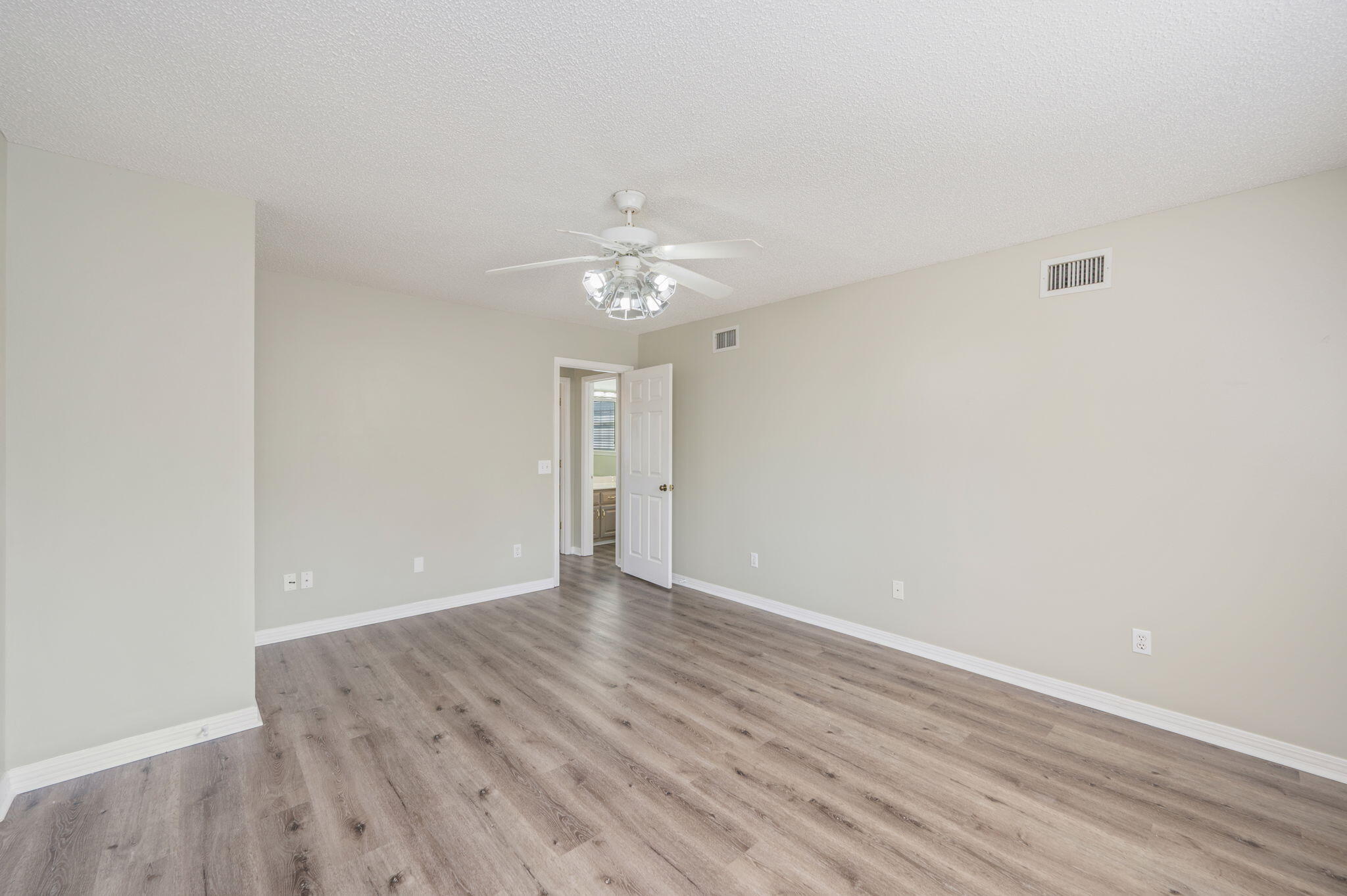 1136 10 Lake Drive DeFuniak Springs, FL 32433 - Photo 35 of 53 a view of an empty room with wooden floor