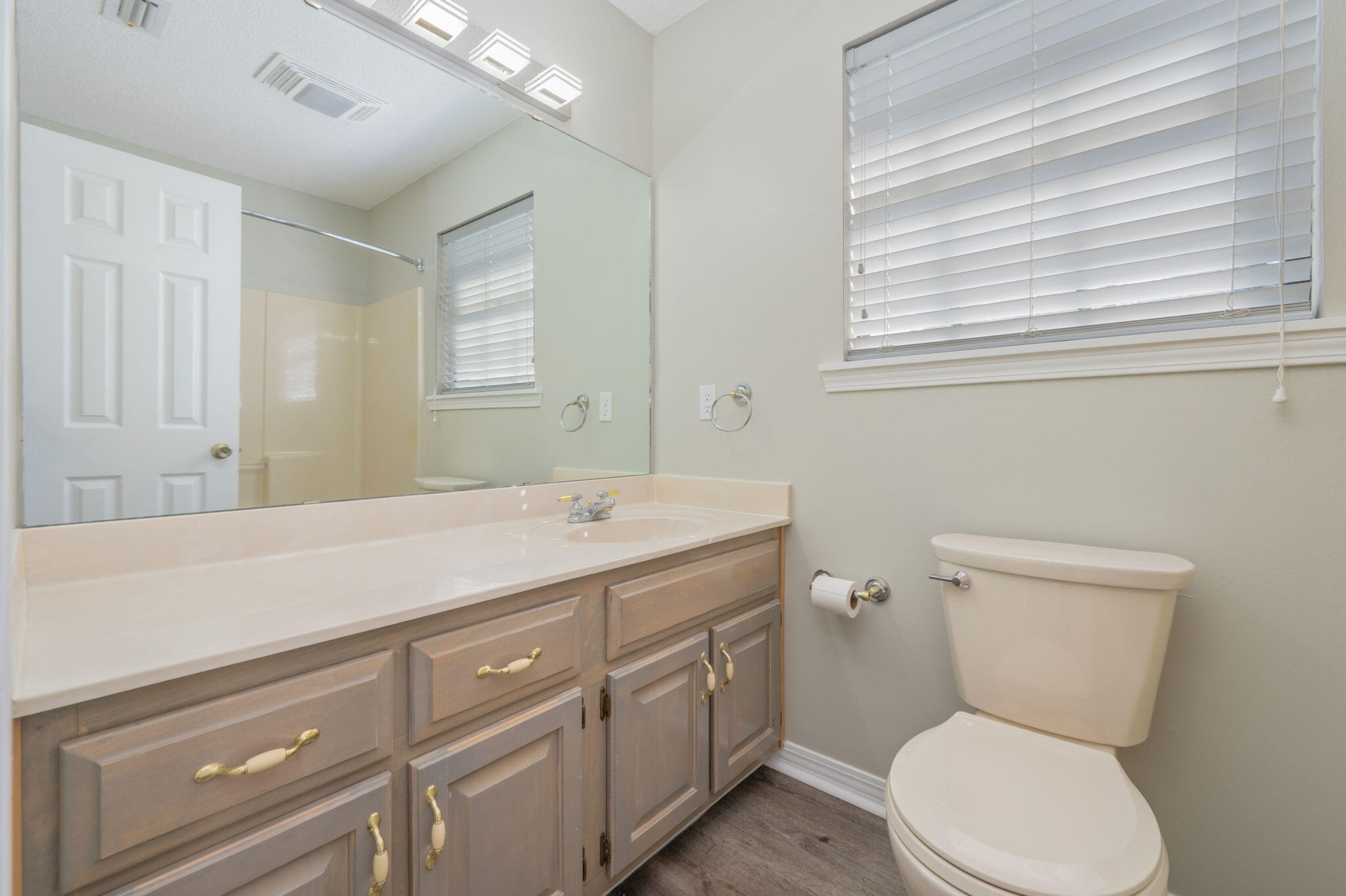 1136 10 Lake Drive DeFuniak Springs, FL 32433 - Photo 36 of 53 a bathroom with a toilet sink and mirror