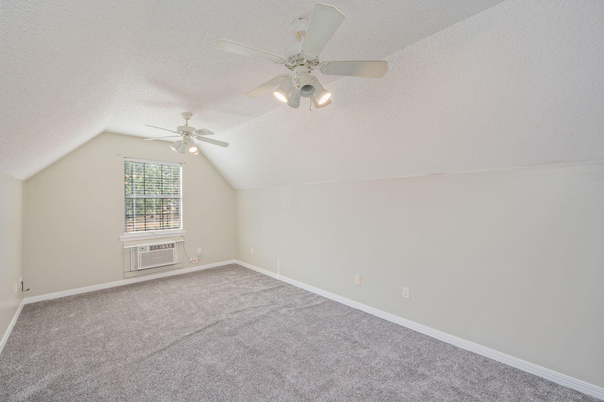 1136 10 Lake Drive DeFuniak Springs, FL 32433 - Photo 41 of 53 an empty room with chandelier fan and windows