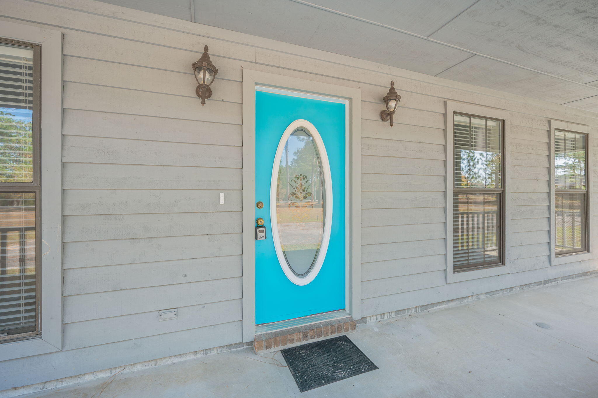 1136 10 Lake Drive DeFuniak Springs, FL 32433 - Photo 7 of 53 a front view of a house with garden