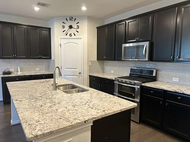 a view of kitchen with cabinets and wooden floor